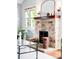 Close up of a stone fireplace with a wood mantel, decorative mirror, and sconce lighting at 315 S Franklin St, Denver, CO 80209