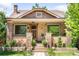 Charming brick home featuring a covered porch, well-maintained landscaping, and inviting curb appeal at 315 S Franklin St, Denver, CO 80209
