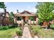 Inviting brick home with a stone walkway, covered porch, and lush green lawn at 315 S Franklin St, Denver, CO 80209