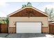 A two-car garage features traditional architecture, a white door, and partial brick exterior at 315 S Franklin St, Denver, CO 80209