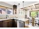 Bright kitchen with granite countertops, wood cabinets, stainless steel appliances, and island next to dining space at 315 S Franklin St, Denver, CO 80209