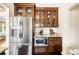 A bright, functional kitchen features stainless steel refrigerator, microwave, and wooden cabinets with glass doors at 315 S Franklin St, Denver, CO 80209