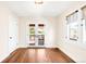 Inviting room with gleaming hardwood floors, white trim, and double doors leading to a charming deck at 315 S Franklin St, Denver, CO 80209
