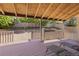Cozy covered back porch overlooks a spacious backyard with mature trees and a privacy fence at 3238 W 11Th Avenue Pl, Broomfield, CO 80020