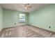 Neutral carpeted bedroom features a window with a wood frame and a ceiling fan at 3238 W 11Th Avenue Pl, Broomfield, CO 80020