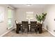Elegant dining room featuring a wooden table with six chairs, neutral walls, and a window offering natural light at 3238 W 11Th Avenue Pl, Broomfield, CO 80020