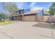 Beautifully maintained home with a brick and blue exterior, a wide driveway, and a well-kept lawn at 3238 W 11Th Avenue Pl, Broomfield, CO 80020