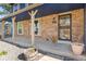 Charming front porch with brick accents, decorative columns, and a secure screen door, offering a welcoming entrance at 3238 W 11Th Avenue Pl, Broomfield, CO 80020
