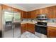 Functional kitchen with stainless steel refrigerator, built-in microwave, and efficient layout at 3238 W 11Th Avenue Pl, Broomfield, CO 80020