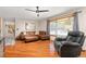 Bright living room featuring hardwood floors, bay window, and comfortable seating at 3238 W 11Th Avenue Pl, Broomfield, CO 80020