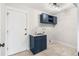 Clean laundry room with navy blue cabinets and a built-in sink at 5152 W Maplewood Pl, Littleton, CO 80123