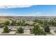 Suburban neighborhood aerial view overlooking the city and mountains in the distance at 21064 Woodside Ln, Parker, CO 80138