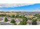 Neighborhood aerial view with homes overlooking the plains and mountains in the distance at 21064 Woodside Ln, Parker, CO 80138
