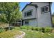 Charming backyard featuring lush landscaping, stepping stones, and a covered patio at 21064 Woodside Ln, Parker, CO 80138