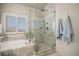 Bathroom features a soaking tub, glass shower, neutral tile, and a window for natural light at 21064 Woodside Ln, Parker, CO 80138