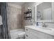 Bathroom features white vanity, marble countertop, shower/tub combo with decor and fixtures at 21064 Woodside Ln, Parker, CO 80138