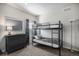Neutral bedroom features metal bunk beds, gray dresser, curtains, and neutral colored carpet at 21064 Woodside Ln, Parker, CO 80138