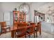 Bright dining room with decorative chandelier, hardwood floors, and views of the modern kitchen at 21064 Woodside Ln, Parker, CO 80138