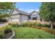 Eye-catching front yard with vibrant flower beds, healthy lawn, and an American flag at 21064 Woodside Ln, Parker, CO 80138