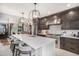 Modern kitchen boasting a large island, stainless steel appliances, and dark wood cabinets at 21064 Woodside Ln, Parker, CO 80138