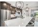Stylish kitchen with a spacious island, stainless steel refrigerator, and designer lighting fixtures at 21064 Woodside Ln, Parker, CO 80138