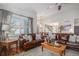 Bright living room showcasing hardwood floors, comfortable seating, and a view into the kitchen at 21064 Woodside Ln, Parker, CO 80138