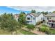 Aerial view of a well-maintained yard featuring lush trees, a fence, and a patio at 21064 Woodside Ln, Parker, CO 80138
