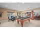 Basement rec room with a pool table, dining table, and bar, perfect for entertaining at 7035 S Picadilly St, Aurora, CO 80016