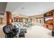 Finished basement with comfortable seating, entertainment center, and natural light, ideal for relaxing and socializing at 7035 S Picadilly St, Aurora, CO 80016