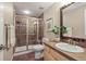 Bathroom featuring a tiled walk-in shower, a modern vanity, and stylish decor at 7035 S Picadilly St, Aurora, CO 80016