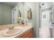 Well-lit bathroom with a cream sink, a large mirror, and a tiled floor, creating a clean and welcoming space at 7035 S Picadilly St, Aurora, CO 80016