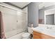 Bathroom featuring a shower and tub combo, tiled walls, and updated vanity at 7035 S Picadilly St, Aurora, CO 80016