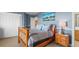 Stylish bedroom with blue walls, a wooden bed frame, and a quaint nightstand with lamp at 7035 S Picadilly St, Aurora, CO 80016