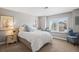 Inviting bedroom with a window seat, providing a cozy spot for reading or relaxing, and charming decor at 7035 S Picadilly St, Aurora, CO 80016