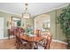 Elegant dining room with green walls, hardwood floors, and a traditional chandelier at 7035 S Picadilly St, Aurora, CO 80016