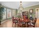 Sunlit dining room with an oval table, bay window, and traditional wooden furniture at 7035 S Picadilly St, Aurora, CO 80016