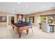 Open-concept game room boasting a pool table, fireplace, and ample seating for entertaining guests at 7035 S Picadilly St, Aurora, CO 80016