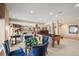 A spacious entertainment area featuring a pool table, dining set, and views of the living room and bar at 7035 S Picadilly St, Aurora, CO 80016