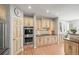 Well-lit kitchen with stainless steel double oven, wooden cabinets, and hardwood flooring at 7035 S Picadilly St, Aurora, CO 80016