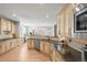 Eat-in kitchen featuring granite counters, modern appliances, and hardwood flooring at 7035 S Picadilly St, Aurora, CO 80016
