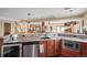 Modern kitchen with granite counters, stainless steel appliances and seamless access to the living and dining area at 7035 S Picadilly St, Aurora, CO 80016