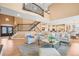 Open-concept living room featuring hardwood floors, a grand staircase, and ample seating at 7035 S Picadilly St, Aurora, CO 80016