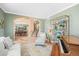Open concept living room with stylish decor, a decorative bookshelf, and seamless flow to dining area at 7035 S Picadilly St, Aurora, CO 80016
