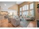 Open concept living room with a fireplace, tall ceilings, and expansive windows at 7035 S Picadilly St, Aurora, CO 80016