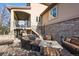 Outdoor patio with stone accents, comfortable seating, fire pit and stairs to the home's upper deck at 7035 S Picadilly St, Aurora, CO 80016