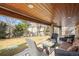 Outdoor patio features wood plank ceilings, stone columns, and plush patio seating at 7035 S Picadilly St, Aurora, CO 80016