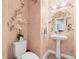 Charming powder room with unique floral wallpaper and a pedestal sink at 7035 S Picadilly St, Aurora, CO 80016