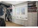 Organized walk-in closet with custom shelving, drawers, and a window seat with a view at 7035 S Picadilly St, Aurora, CO 80016