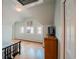Bedroom featuring hardwood floors, natural light, a dresser with a TV, and access to other parts of the home at 1165 N Pennsylvania St # 3B, Denver, CO 80203