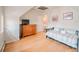 Bedroom featuring hardwood floors, a daybed, and a dresser with natural light coming through the window at 1165 N Pennsylvania St # 3B, Denver, CO 80203